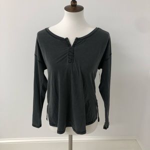 A gray long sleeve with hooks on the top